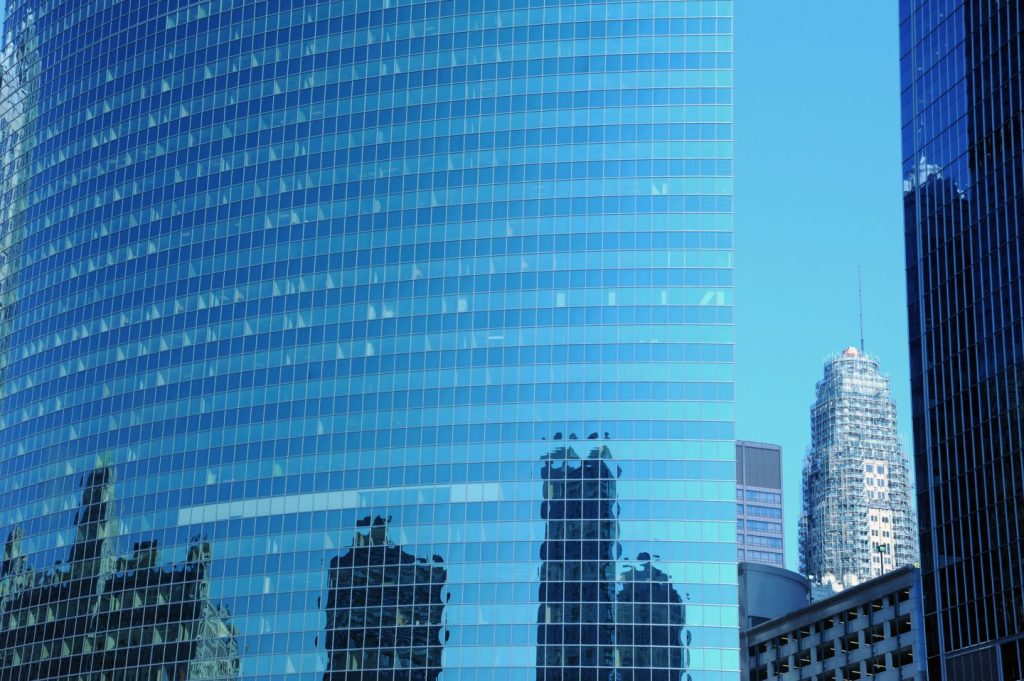 Reflection of skyscrapers in a rounded faced steel and glass tower, a tower under construction, contemporary architecture, sunny day, summer, downtown Chicago, Illinois, USA
