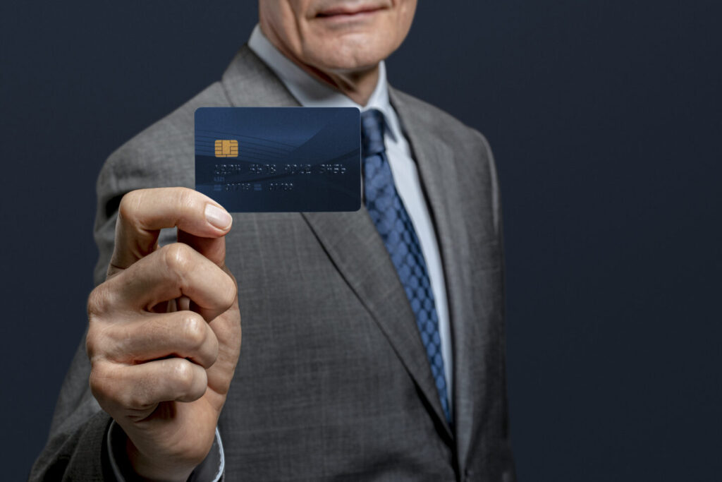 Businessman showing a credit card