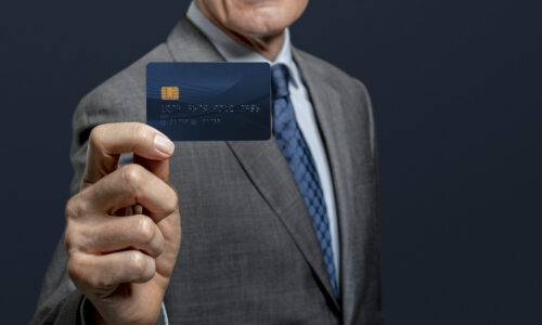 Businessman showing a credit card