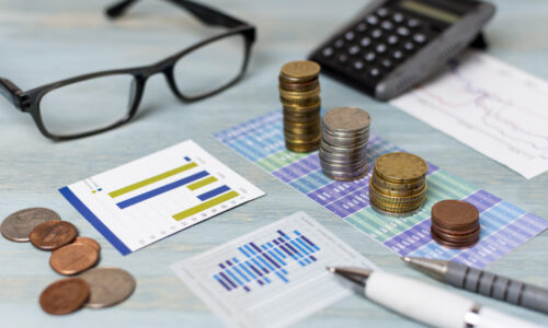 reading-glasses-piles-coins-high-view